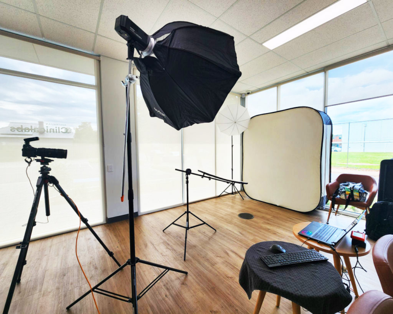 Our mobile photography studio set up in an office with professional lighting, a background, camera and image-review workstation